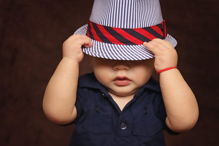 baby boy with hat covering face-capsule wardrobe for toddlers